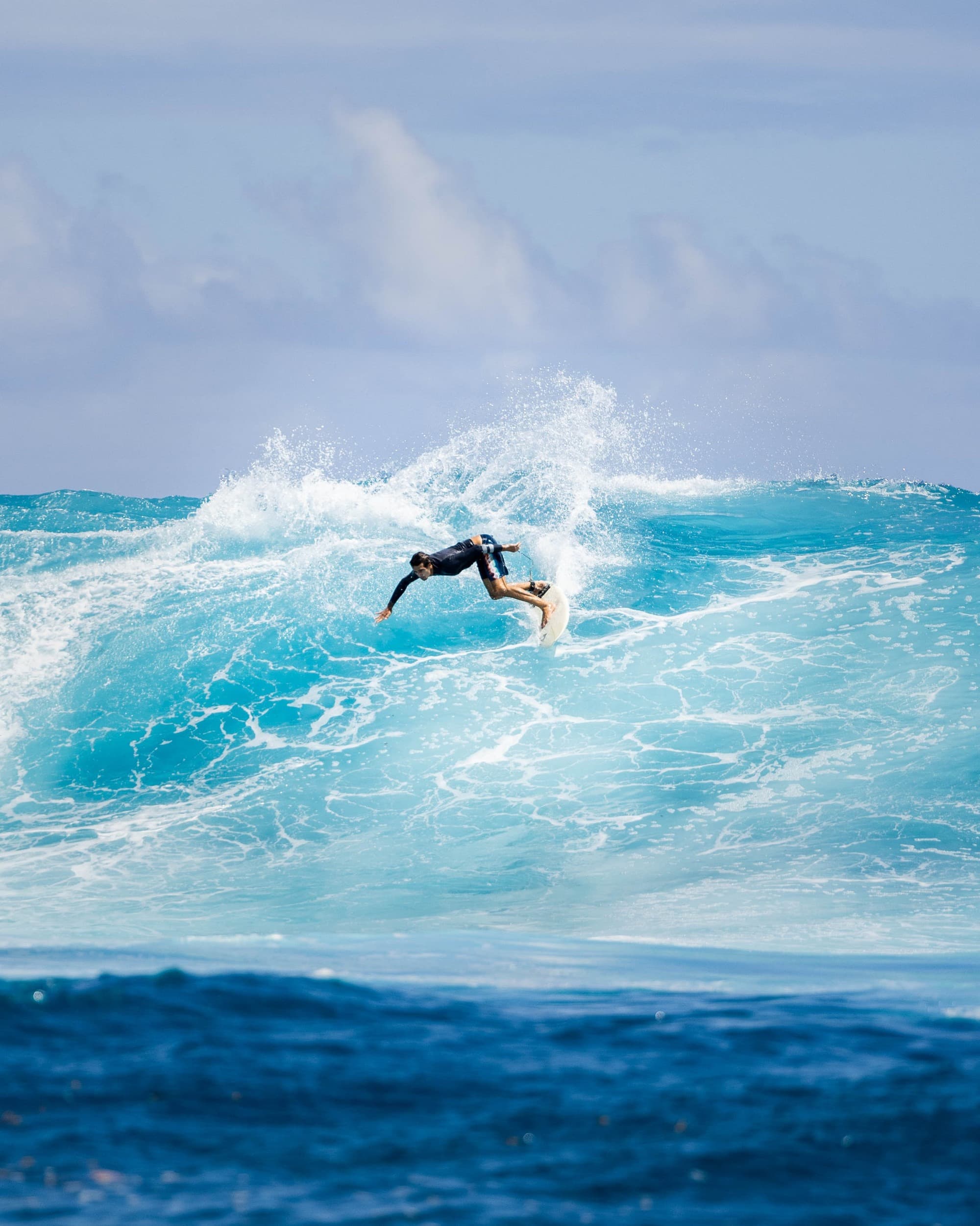 Surfer in clear blue water